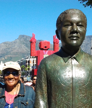 Stevenson next to a statue of Nelson Mandela during South Africa tour.